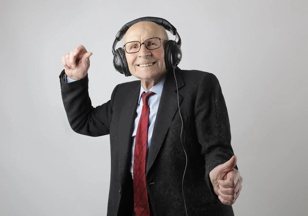Happy elderly man with headphones accessing WCAG-compliant accessible content